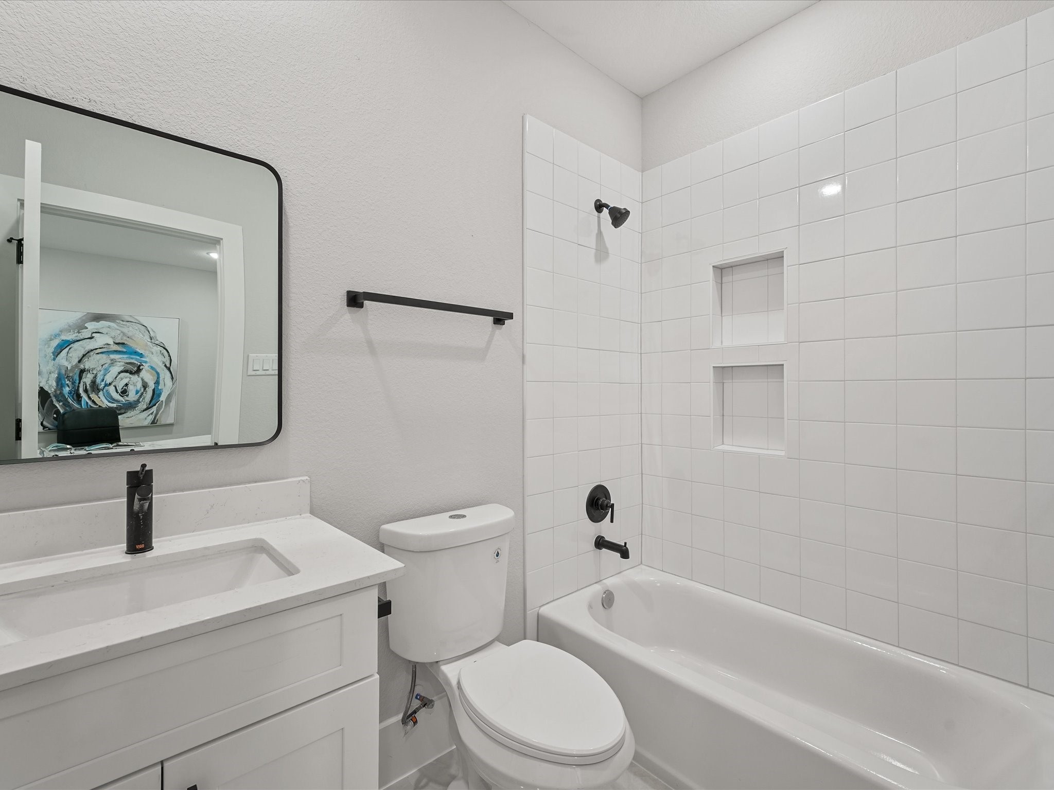 4812 Cochran Street Houston, TX 77009 - Photo 6 of 30 a bathroom with a toilet sink a mirror a vanity and bathtub