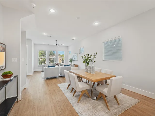 a view of a dining room with furniture and wooden floor