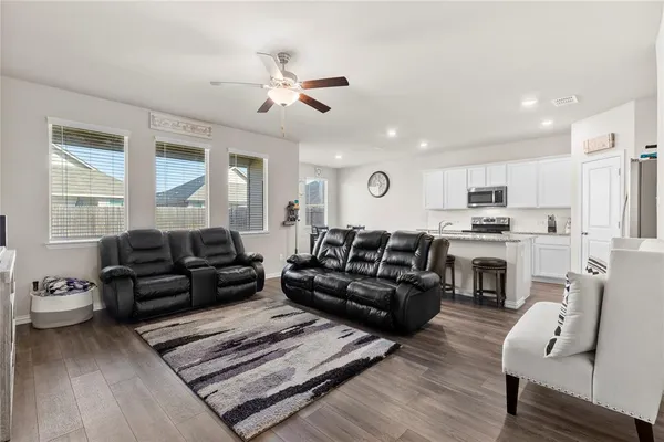 a living room with furniture fireplace and a window