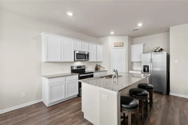 a kitchen with a sink stove and refrigerator