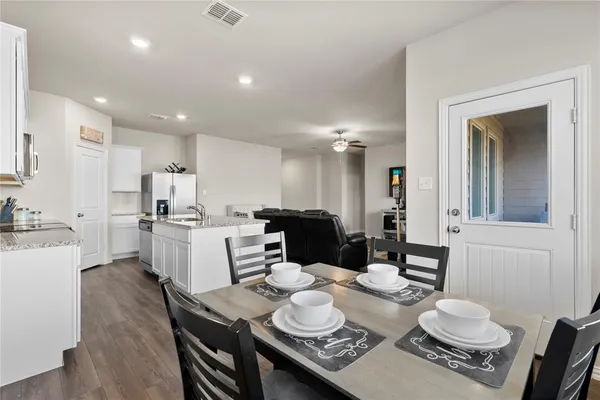 a dining room with furniture and wooden floor