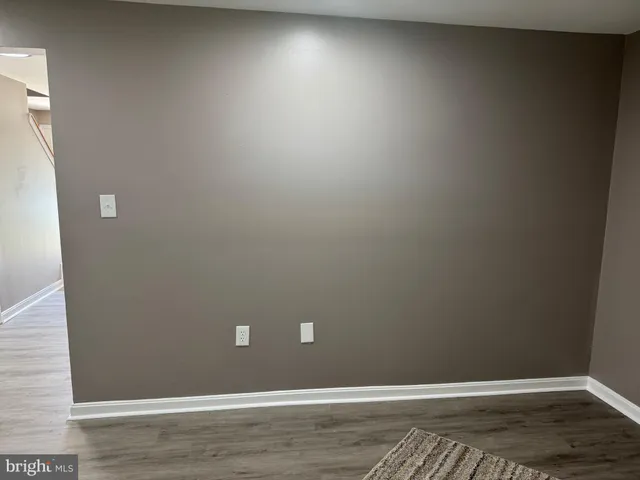 a kitchen with granite countertop wooden cabinets and a stove top oven