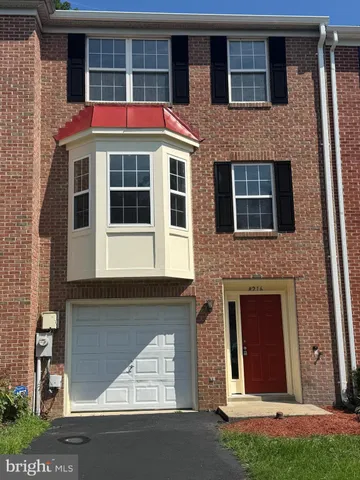 a front view of a building with a yard and garage
