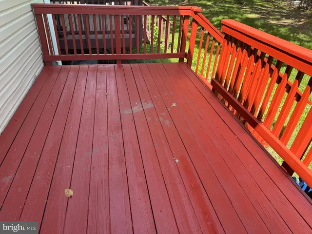 a view of empty room with wooden floor and fireplace