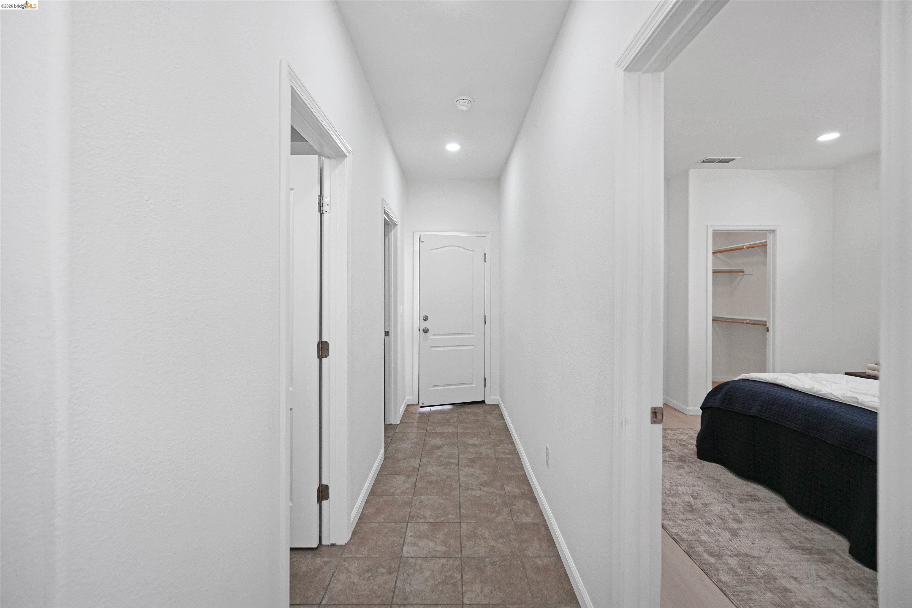 449 Constantine Court San Ramon, CA 94583 - Photo 48 of 63 Hallway featuring recessed lighting, paneled doors, and square tile flooring
