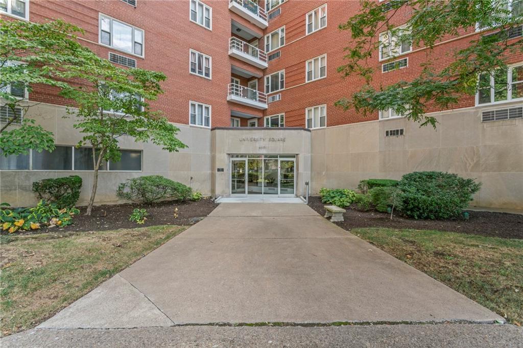 front view of a brick house with a yard
