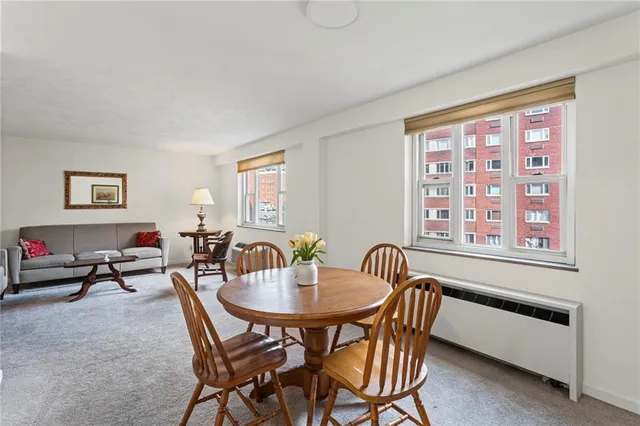 a dining room with furniture and window