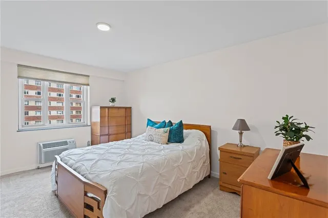 a bedroom with a bed and a potted plant