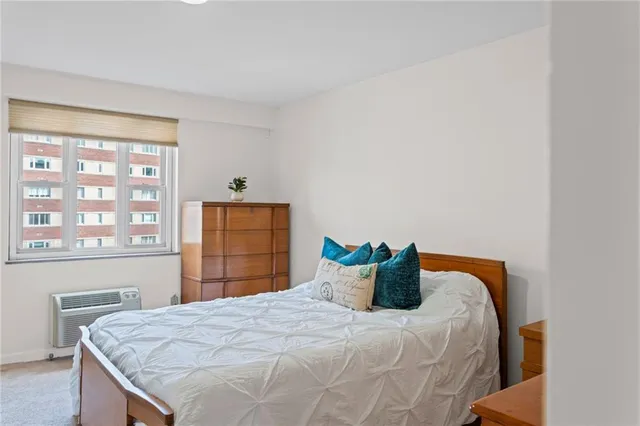 a bedroom with a bed and window