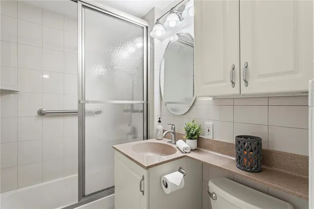 a bathroom with a sink a mirror and a shower