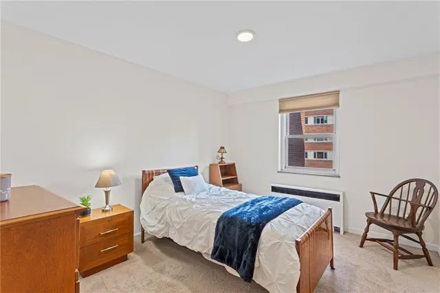 a bedroom with a bed and chair