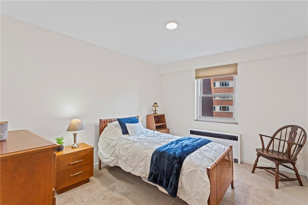 4601 Fifth Avenue, Unit 525 Pittsburgh, PA 15213 - Photo 19 of 35 a bedroom with a bed and chair