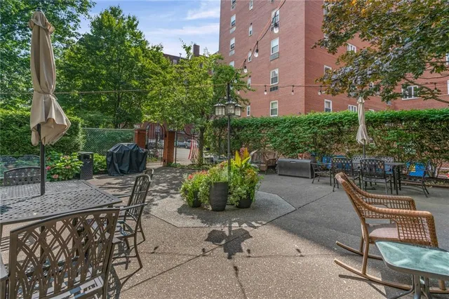 a backyard of a house with table and chairs