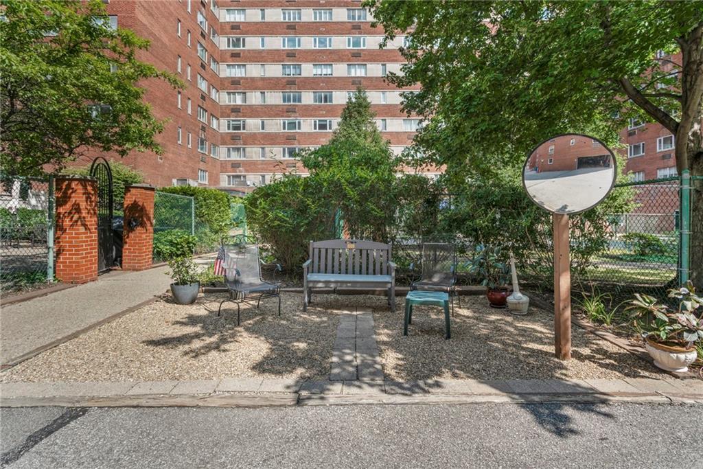 4601 Fifth Avenue, Unit 525 Pittsburgh, PA 15213 - Photo 29 of 35 a view of a patio with table and chairs potted plants and wooden fence