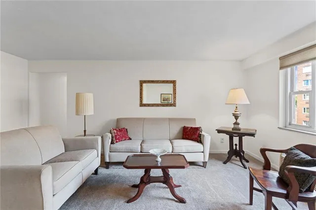 a living room with furniture and a lamp
