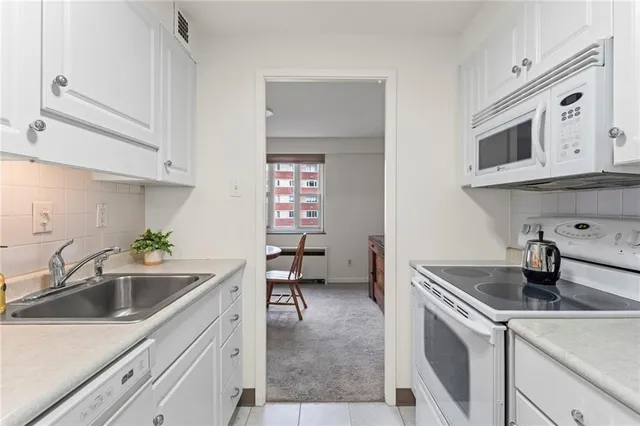 a kitchen with stainless steel appliances granite countertop a sink and a microwave