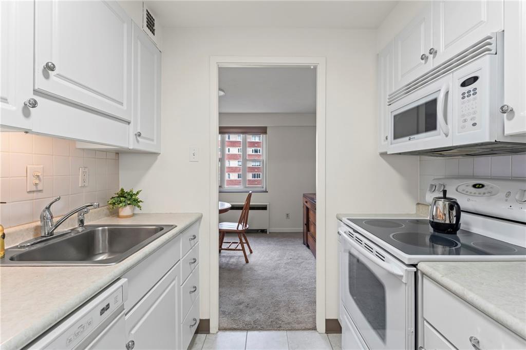 4601 Fifth Avenue, Unit 525 Pittsburgh, PA 15213 - Photo 5 of 35 a kitchen with stainless steel appliances granite countertop a sink and a microwave