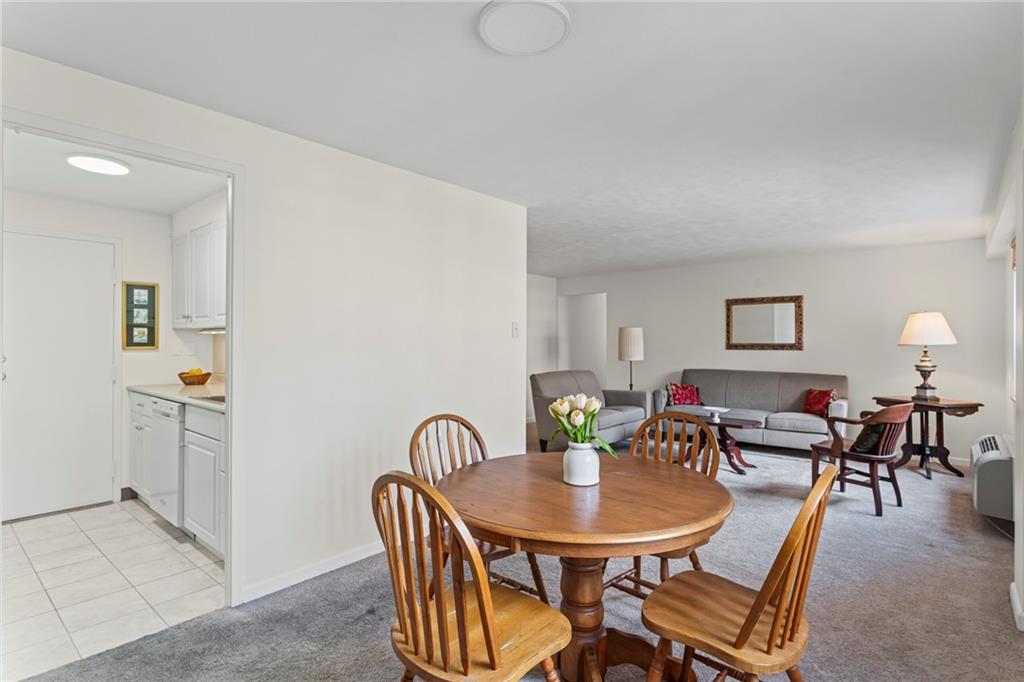4601 Fifth Avenue, Unit 525 Pittsburgh, PA 15213 - Photo 8 of 35 a view of a dining room with furniture and chandelier