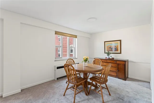 a view of a dining room with furniture and window