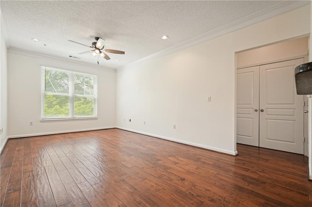 10 Perimeter Summit Boulevard, Unit 2207 Brookhaven, GA 30319 - Photo 1 of 49 a view of empty room with wooden floor and fan