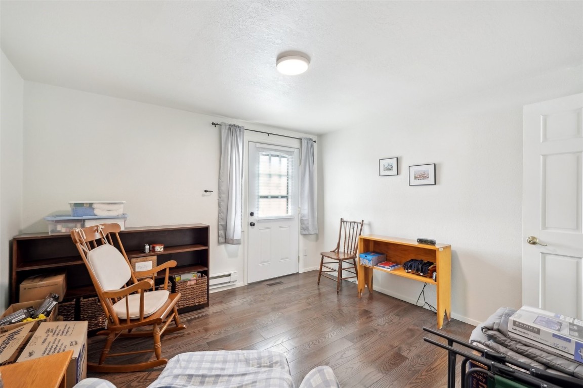 416 Cascade Circle Silverthorne, CO 80498 - Photo 16 of 49 Living area with baseboard heating, baseboards, and wood finished floors