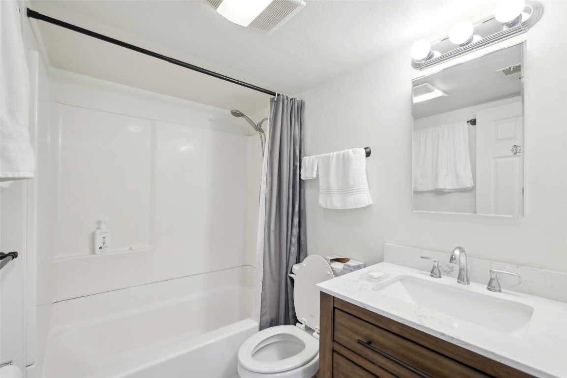416 Cascade Circle Silverthorne, CO 80498 - Photo 24 of 49 Bathroom featuring shower / bathtub combination with curtain, toilet, visible vents, and vanity