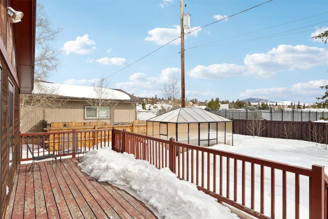 416 Cascade Circle Silverthorne, CO 80498 - Photo 38 of 49 Snow covered deck featuring an outdoor structure and a fenced backyard