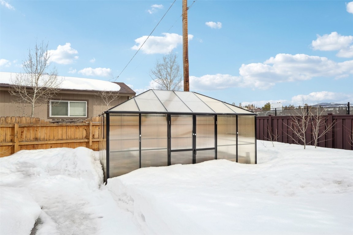 416 Cascade Circle Silverthorne, CO 80498 - Photo 39 of 49 Snowy yard featuring an exterior structure, an outdoor structure, and fence