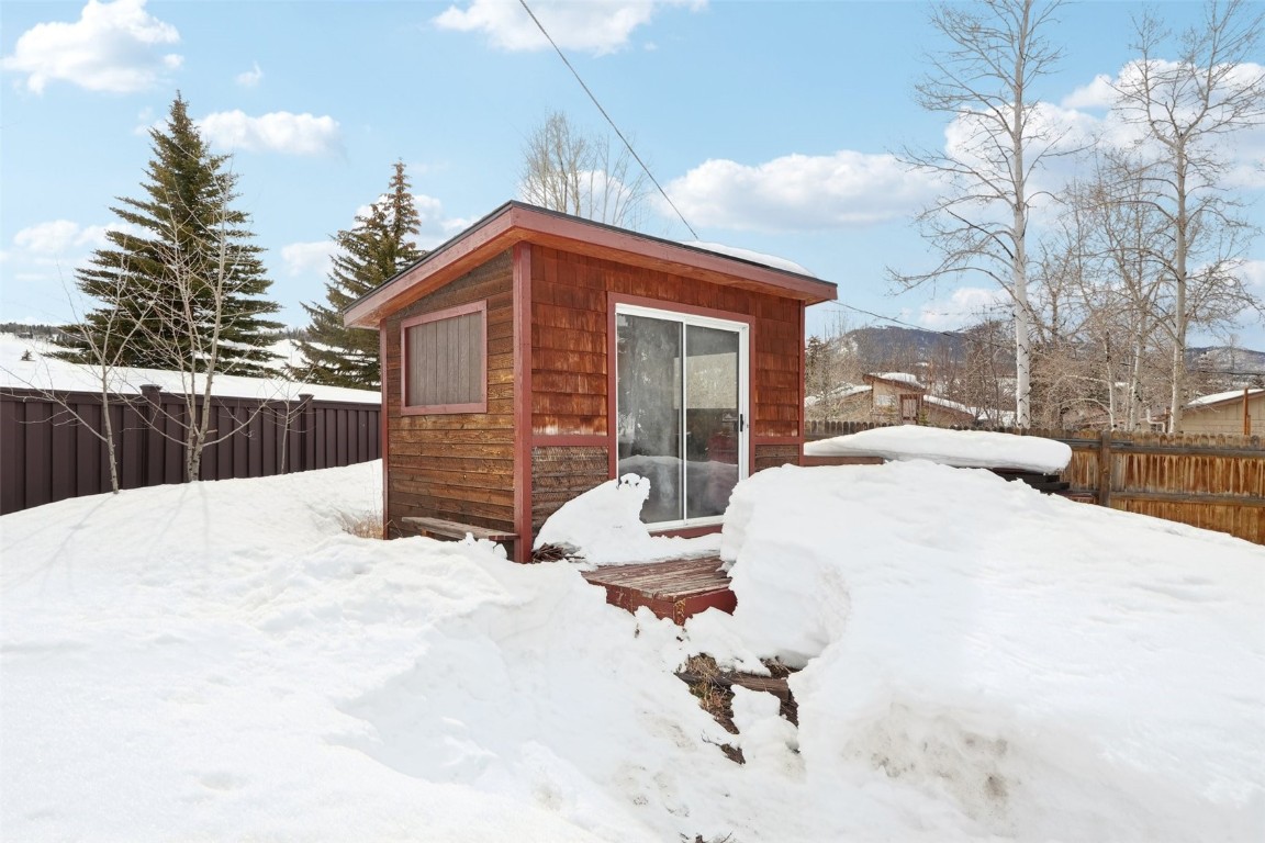 416 Cascade Circle Silverthorne, CO 80498 - Photo 40 of 49 Snow covered structure with an outbuilding and a fenced backyard