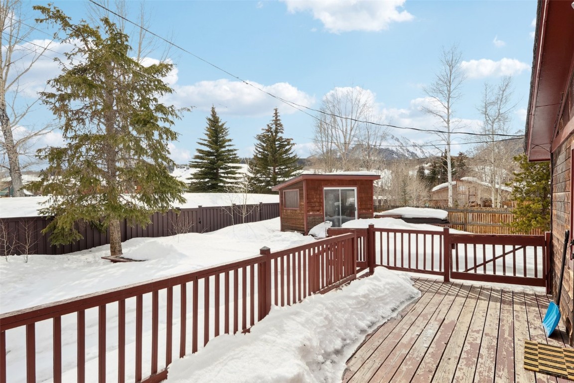 416 Cascade Circle Silverthorne, CO 80498 - Photo 41 of 49 Snow covered deck featuring an outbuilding and a fenced backyard