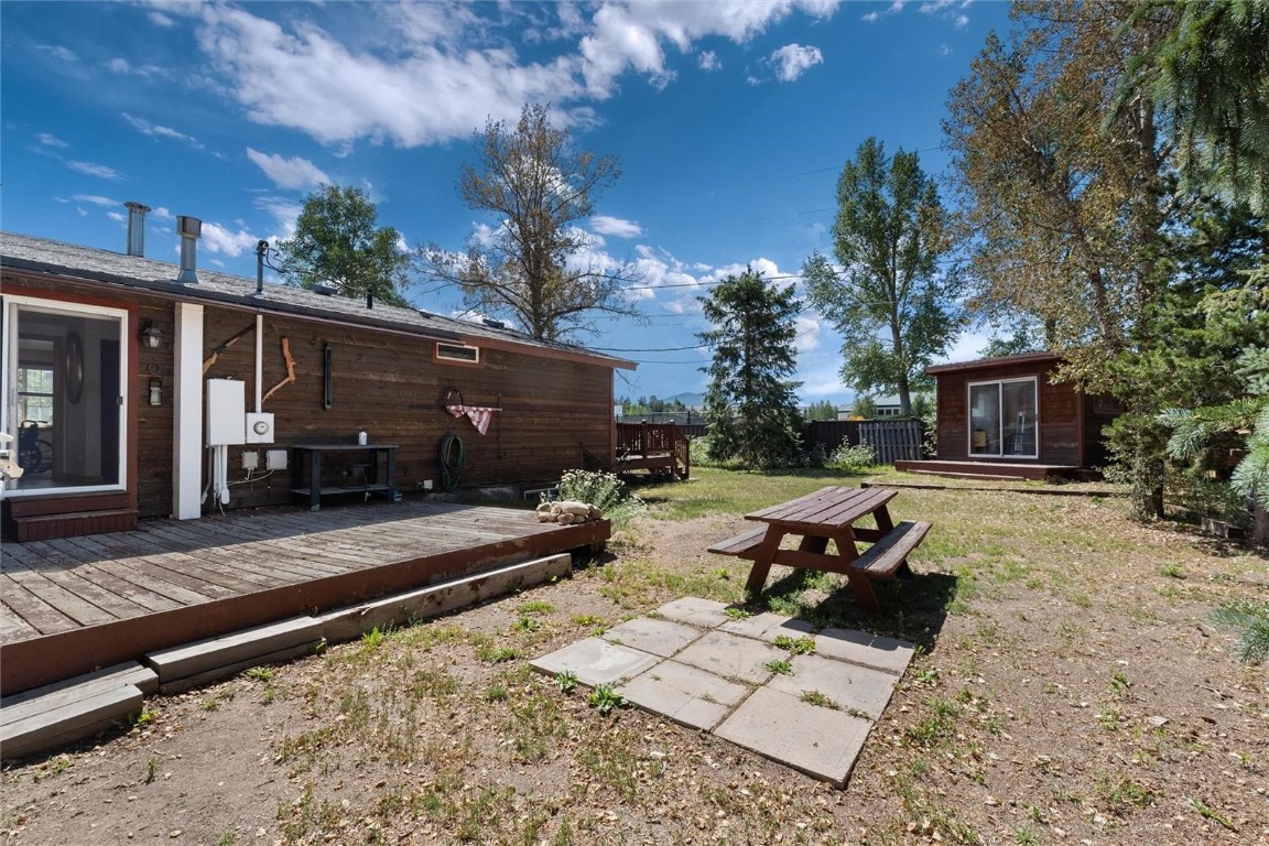 416 Cascade Circle Silverthorne, CO 80498 - Photo 42 of 49 View of yard with a wooden deck and an outbuilding