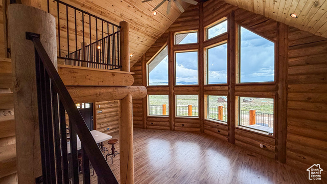 5236 North Holly Way Helper, UT 84526 - Photo 7 of 34 Unfurnished living room featuring high vaulted ceiling, hardwood / wood-style floors, log walls, wood ceiling, and a ceiling fan