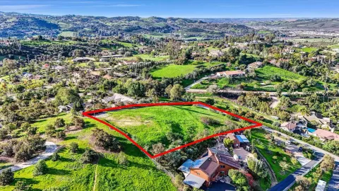 an aerial view of residential houses with outdoor space and swimming pool