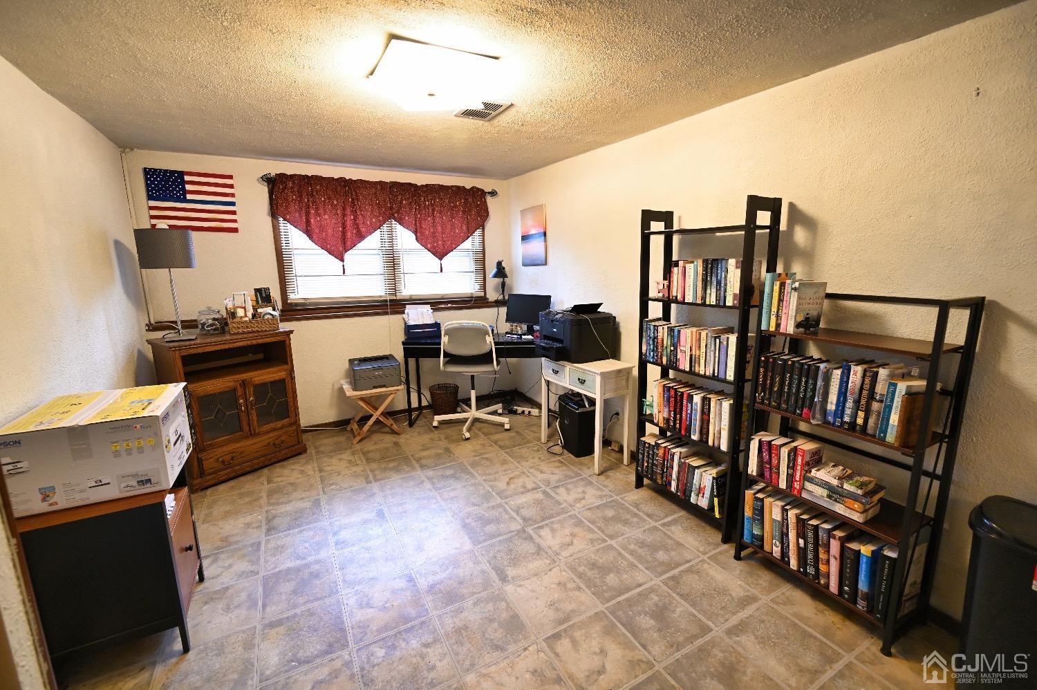 831 Colonial Arms Road Union, NJ 07083 - Photo 13 of 19 a room with lots of furniture and a book shelf