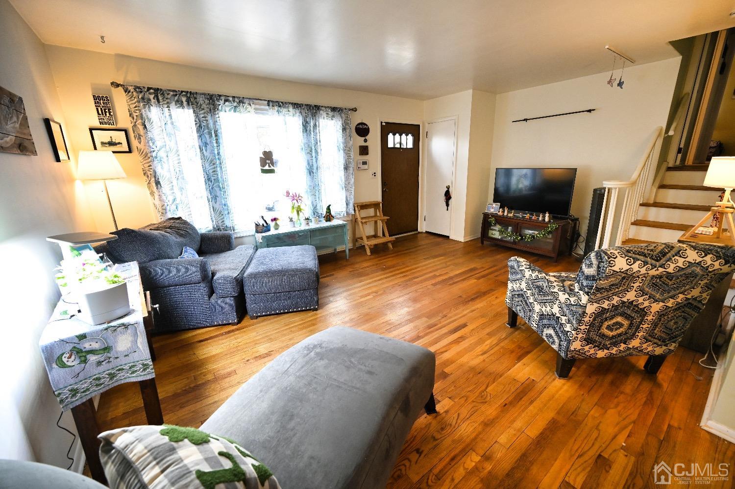831 Colonial Arms Road Union, NJ 07083 - Photo 3 of 19 a living room with furniture fireplace and a flat screen tv