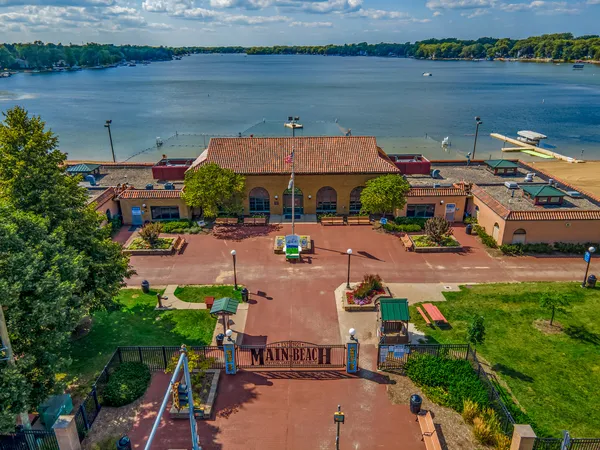 an aerial view of a house with a garden and lake view