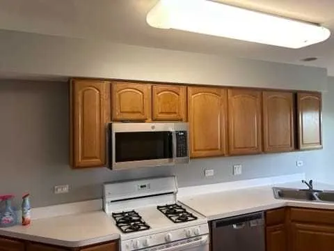 a kitchen with a sink a stove and cabinets