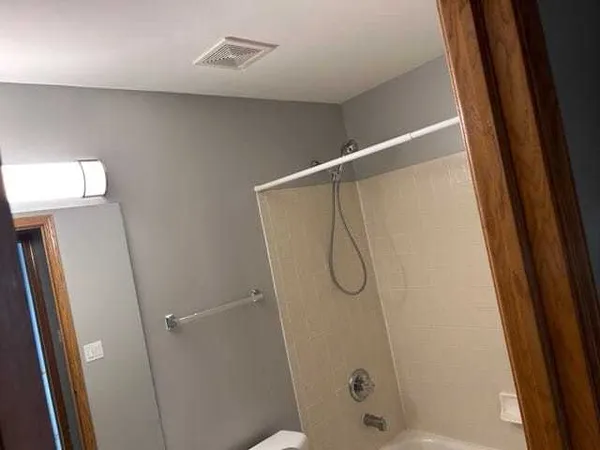 a bathroom with a glass shower door
