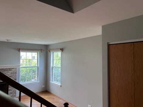 2456 Frost Drive Aurora, IL 60503 - Photo 4 of 12 a view of an empty room with wooden floor and windows