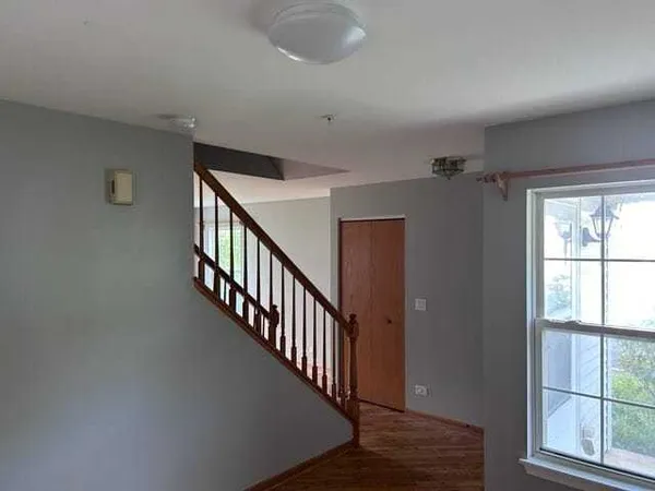 a view of an entryway with wooden floor
