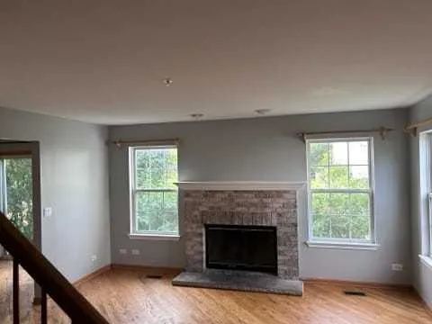 a living room with a fireplace and windows