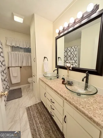 a bathroom with a double vanity sink and a mirror