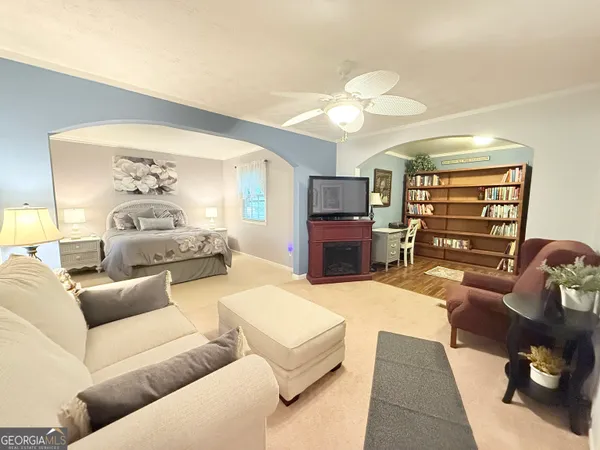a living room with furniture a fireplace and a flat screen tv