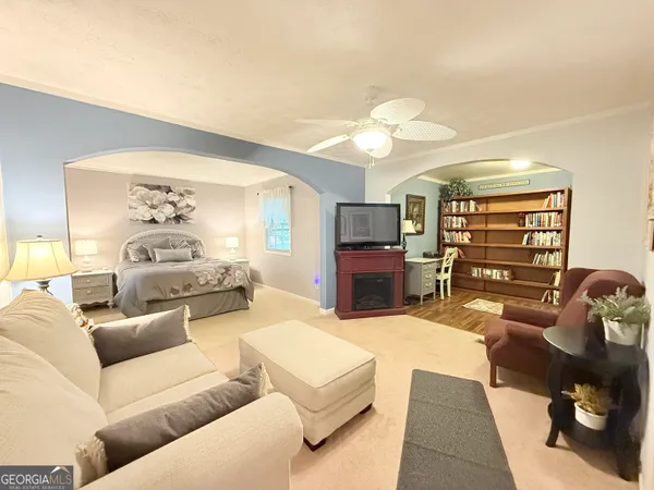 a living room with furniture a couch and a chandelier