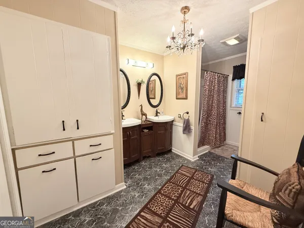 a bathroom with a double vanity sink mirror and shower