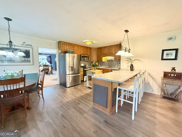 a view of a dining room with furniture and wooden floor