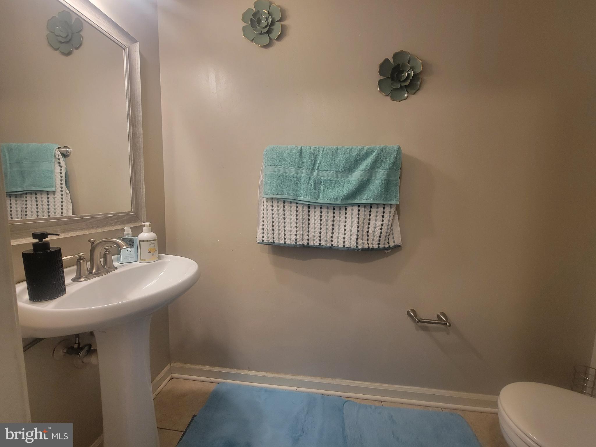 4634 Deepwood Court, Unit 89E Bowie, MD 20720 - Photo 13 of 29 a bathroom with a sink toilet and a mirror
