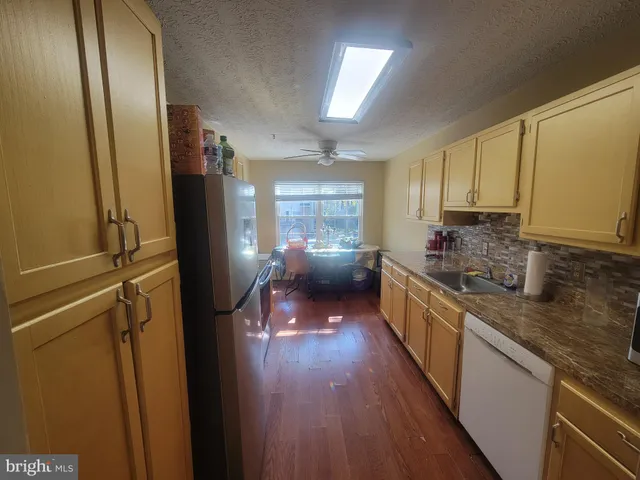 a kitchen with stainless steel appliances a sink stove and cabinets