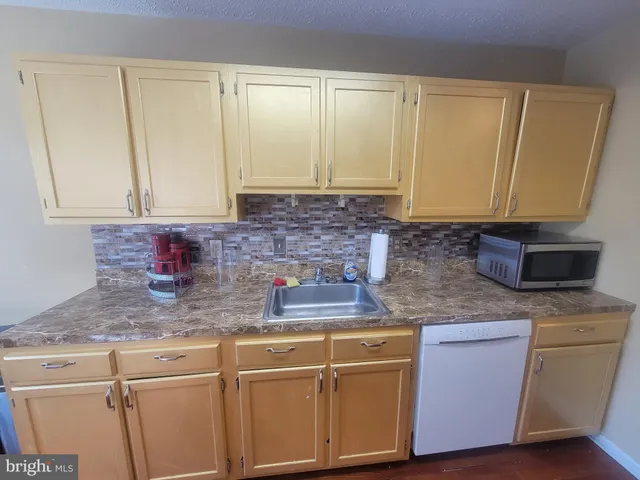 a kitchen with a refrigerator sink and stove