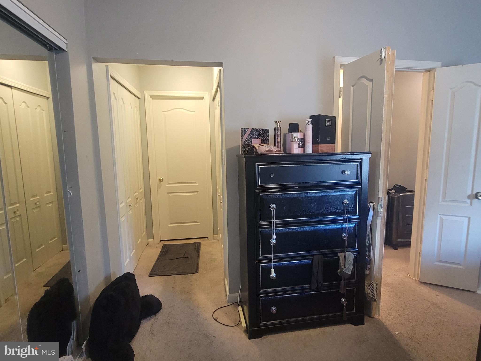 4634 Deepwood Court, Unit 89E Bowie, MD 20720 - Photo 23 of 29 a room with a dresser and a mirror